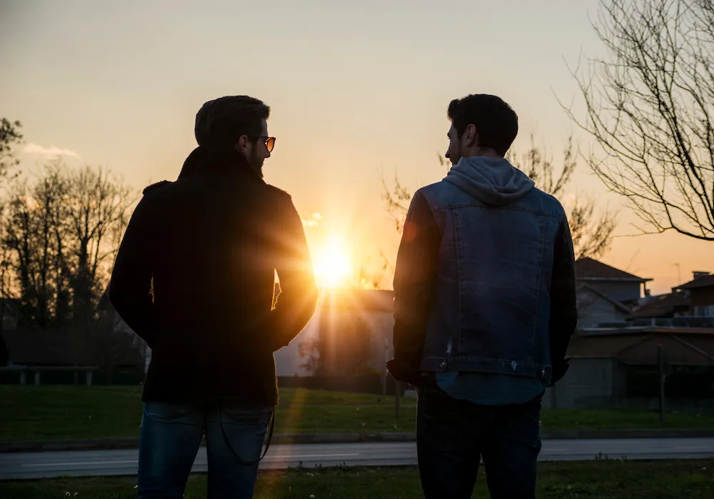 Two young men watching the sunset